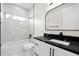 Modern bathroom featuring a unique mirror, black hardware, and marble-tiled shower and backsplash at 13619 Sw 78Th Place, Dunnellon, FL 34432