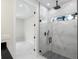 Bathroom featuring glass enclosed shower with marble tile and pebble floor at 13619 Sw 78Th Place, Dunnellon, FL 34432