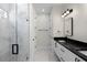 Bathroom featuring double vanity with black marble countertop and glass enclosed shower at 13619 Sw 78Th Place, Dunnellon, FL 34432