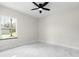 Bedroom with marble floors, ceiling fan, and a bright window at 13619 Sw 78Th Place, Dunnellon, FL 34432