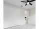A well-lit bedroom showcases a spacious closet with sleek white doors and a modern ceiling fan at 13619 Sw 78Th Place, Dunnellon, FL 34432