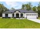 Charming single-story home with a well-manicured lawn, arched windows and a two car garage at 13619 Sw 78Th Place, Dunnellon, FL 34432