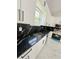 Modern kitchen featuring white cabinets, stainless appliances, and black marble countertops at 13619 Sw 78Th Place, Dunnellon, FL 34432