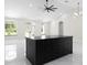 Modern kitchen boasts a black kitchen island with barstool seating, open to the airy living space at 13619 Sw 78Th Place, Dunnellon, FL 34432