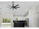 Stylish kitchen view showcases a black island, stainless steel appliances, and elegant lighting, all set in a modern design at 13619 Sw 78Th Place, Dunnellon, FL 34432