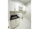 Functional laundry area with sink, storage cabinets, and utility connections at 13619 Sw 78Th Place, Dunnellon, FL 34432
