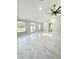 Bright, open concept living space featuring sleek tile flooring and contemporary ceiling fan at 13619 Sw 78Th Place, Dunnellon, FL 34432