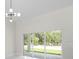 Bright living room featuring a modern chandelier and sliding glass doors to the backyard at 13619 Sw 78Th Place, Dunnellon, FL 34432