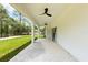 Long, covered patio offering a serene outdoor space, connecting seamlessly to the lush backyard at 13619 Sw 78Th Place, Dunnellon, FL 34432
