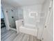 Bright bathroom featuring a glass-enclosed shower and a separate soaking tub at 14501 Grove Resort Ave # 3737, Winter Garden, FL 34787