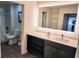 Well-lit bathroom with a vanity, storage, large mirror, and a separate toilet and shower area at 14501 Grove Resort Ave # 3737, Winter Garden, FL 34787