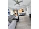 Open-concept living room with wood floors, ceiling fan, and lots of natural light at 14501 Grove Resort Ave # 3737, Winter Garden, FL 34787