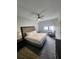 Relax in this bedroom with comfy king-size bed, ceiling fan, and large window at 14501 Grove Resort Ave # 3737, Winter Garden, FL 34787