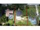 Red outline over property in aerial view showing mature trees, private pool, neighborhood, and large lot at 1462 Mt Laurel Dr, Winter Springs, FL 32708