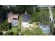 Aerial view of home showing mature trees, a private pool, neighborhood, and large lot at 1462 Mt Laurel Dr, Winter Springs, FL 32708