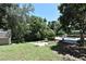 Inviting backyard featuring a private pool, mature trees and a cozy firepit area for relaxing and entertaining outdoors at 1462 Mt Laurel Dr, Winter Springs, FL 32708