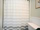 Clean and bright bathroom with a striped shower curtain and white toilet at 1462 Mt Laurel Dr, Winter Springs, FL 32708