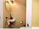 Cozy powder room with unique features, including a pedestal sink and decorative mirror at 1462 Mt Laurel Dr, Winter Springs, FL 32708