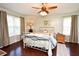 Charming bedroom featuring hardwood floors, two windows, and a ceiling fan at 1462 Mt Laurel Dr, Winter Springs, FL 32708