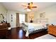 Bright bedroom featuring hardwood floors, a ceiling fan, and warm decor at 1462 Mt Laurel Dr, Winter Springs, FL 32708