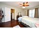 Bedroom with hardwood floors, a ceiling fan, an ensuite, and a walk-in closet at 1462 Mt Laurel Dr, Winter Springs, FL 32708