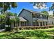 Traditional gray two-story home with manicured lawn and mature trees at 1462 Mt Laurel Dr, Winter Springs, FL 32708