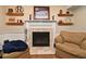 Living room showcasing a beautiful fireplace with mantel, complemented by shelving and comfortable seating at 1462 Mt Laurel Dr, Winter Springs, FL 32708