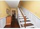 Bright foyer featuring hardwood floors and staircase with storage at 1462 Mt Laurel Dr, Winter Springs, FL 32708