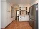 Spacious kitchen with custom cabinets, stainless steel refrigerator, and tiled floors at 1462 Mt Laurel Dr, Winter Springs, FL 32708