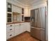 Modern kitchen with stainless steel refrigerator, custom cabinetry and tiled floors at 1462 Mt Laurel Dr, Winter Springs, FL 32708