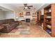 Cozy living room with fireplace, custom bookshelves, and tile flooring, ideal for relaxation and entertainment at 1462 Mt Laurel Dr, Winter Springs, FL 32708