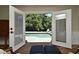Serene pool view framed by open doors from a sunroom, creating an indoor-outdoor oasis at 1462 Mt Laurel Dr, Winter Springs, FL 32708