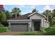 Charming single-story home with gray exterior, a two-car garage, and tropical landscaping in a sunny neighborhood at 152 Fredericksburg Ave, Orange City, FL 32763