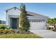 Charming single-Gathering home featuring a two-car garage, minimalist landscaping, and a modern front door at 152 Fredericksburg Ave, Orange City, FL 32763