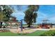 Community playground with swings, slides, a gazebo, and a soft play surface surrounded by green space at 152 Fredericksburg Ave, Orange City, FL 32763