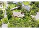 Aerial view of a well-maintained property with lush landscaping and mature trees in a serene neighborhood at 1600 N Wind Ct, Winter Springs, FL 32708