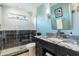 Updated bathroom featuring a stylish vanity with granite countertop and a glass-enclosed shower with modern tile at 1600 N Wind Ct, Winter Springs, FL 32708
