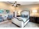 Bedroom with comfortable bed, plush seating, and elegant bedside lighting at 1600 N Wind Ct, Winter Springs, FL 32708