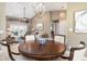 Dining room adjacent to living room with grand chandelier and lovely round table at 1600 N Wind Ct, Winter Springs, FL 32708