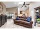 Comfortable living room with a leather sofa, a skylight, and an open view of the kitchen at 1600 N Wind Ct, Winter Springs, FL 32708