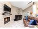 Cozy living room with a stone fireplace, comfortable leather sofa, and a view of the patio at 1600 N Wind Ct, Winter Springs, FL 32708