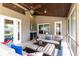 Covered patio with comfortable seating and ceiling fan, perfect for outdoor relaxation and entertaining guests at 1600 N Wind Ct, Winter Springs, FL 32708