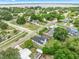 Aerial of neighborhood showcasing the community's mature trees, varied architecture, and proximity to a lake at 161 Bolender Rd, Auburndale, FL 33823