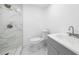 Bright bathroom featuring a modern vanity, toilet, and a beautifully tiled shower with glass door at 161 Bolender Rd, Auburndale, FL 33823