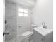 Bright bathroom features a modern vanity, toilet, and a beautifully tiled shower with glass door at 161 Bolender Rd, Auburndale, FL 33823