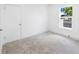 Cozy bedroom featuring soft carpeting, fresh white walls, a window, and modern trim at 161 Bolender Rd, Auburndale, FL 33823