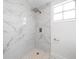 Beautiful shower featuring rainfall shower head, modern fixtures, and white marble style large format tile at 161 Bolender Rd, Auburndale, FL 33823