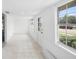 Bright sun room filled with natural light, tiled floors, and crisp white walls, highlighting the airy space at 161 Bolender Rd, Auburndale, FL 33823