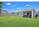 Well-manicured backyard featuring lush green grass and a screened-in patio at 1821 Benevento St, St Cloud, FL 34771