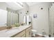 Bathroom featuring double sinks, neutral color palette, shower with modern curtain, and artwork at 1821 Benevento St, St Cloud, FL 34771